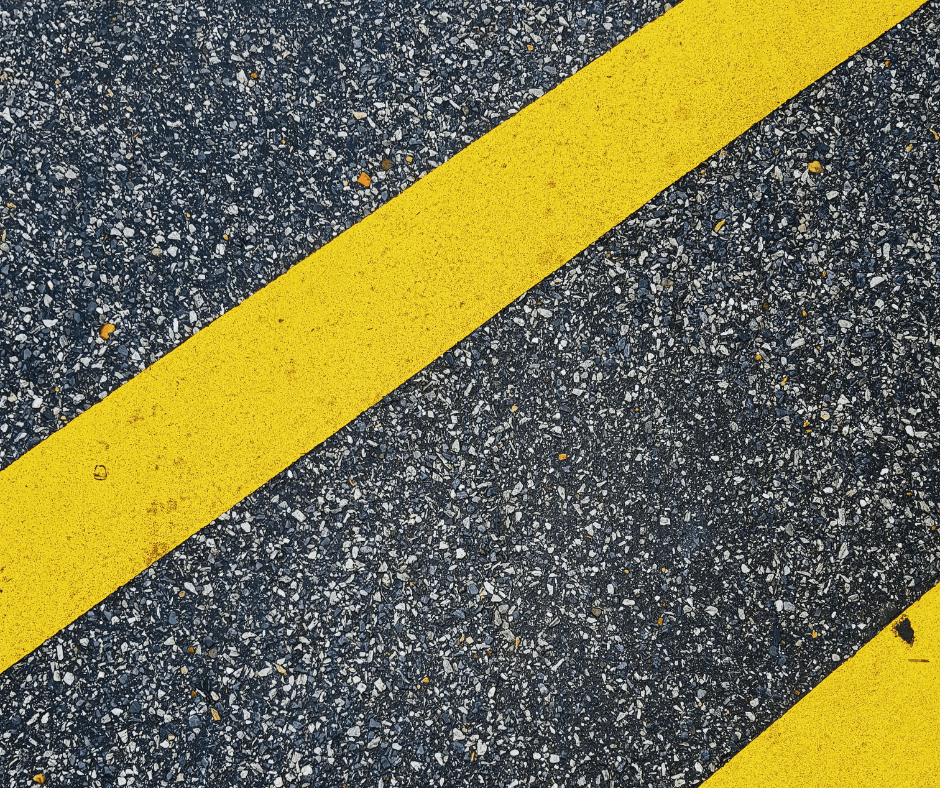 two yellow lines on black asphalt