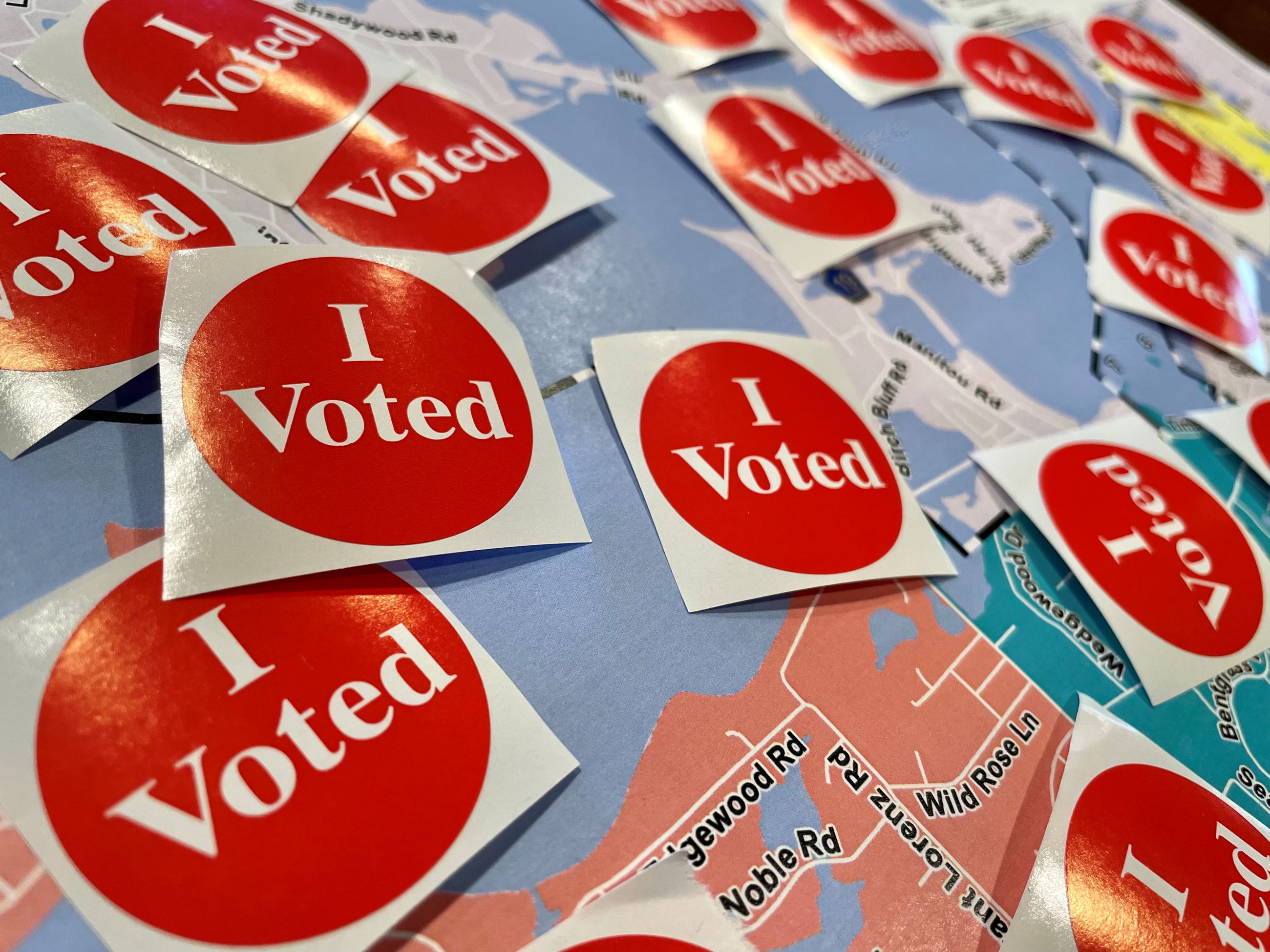 I voted stickers laying on top of shorewood precinct map